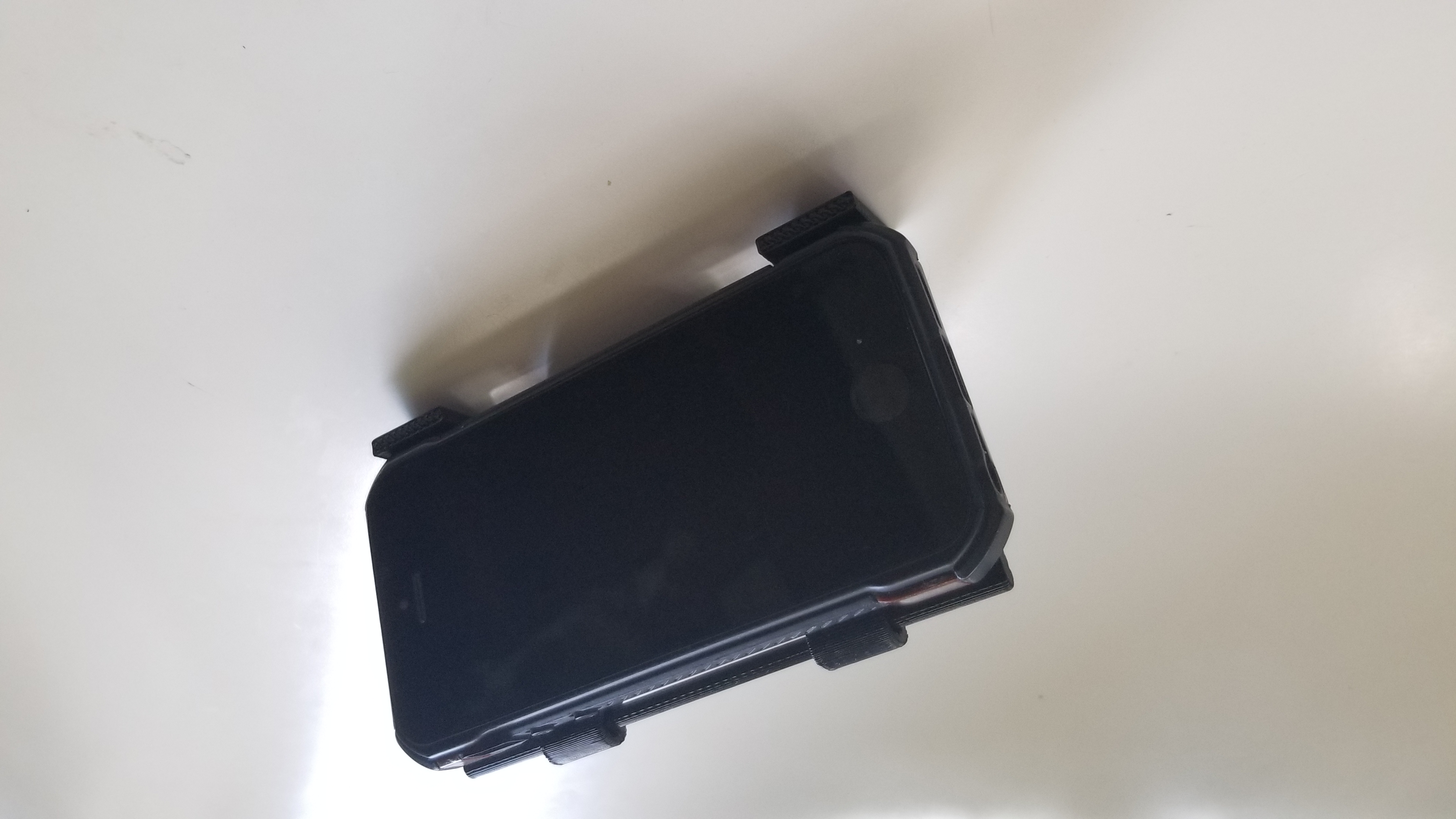 Printed design holding a smaller phone
